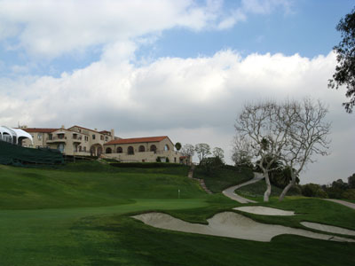 An intimidating tee shot and a sloping fairway make this long finishing hole a tough par